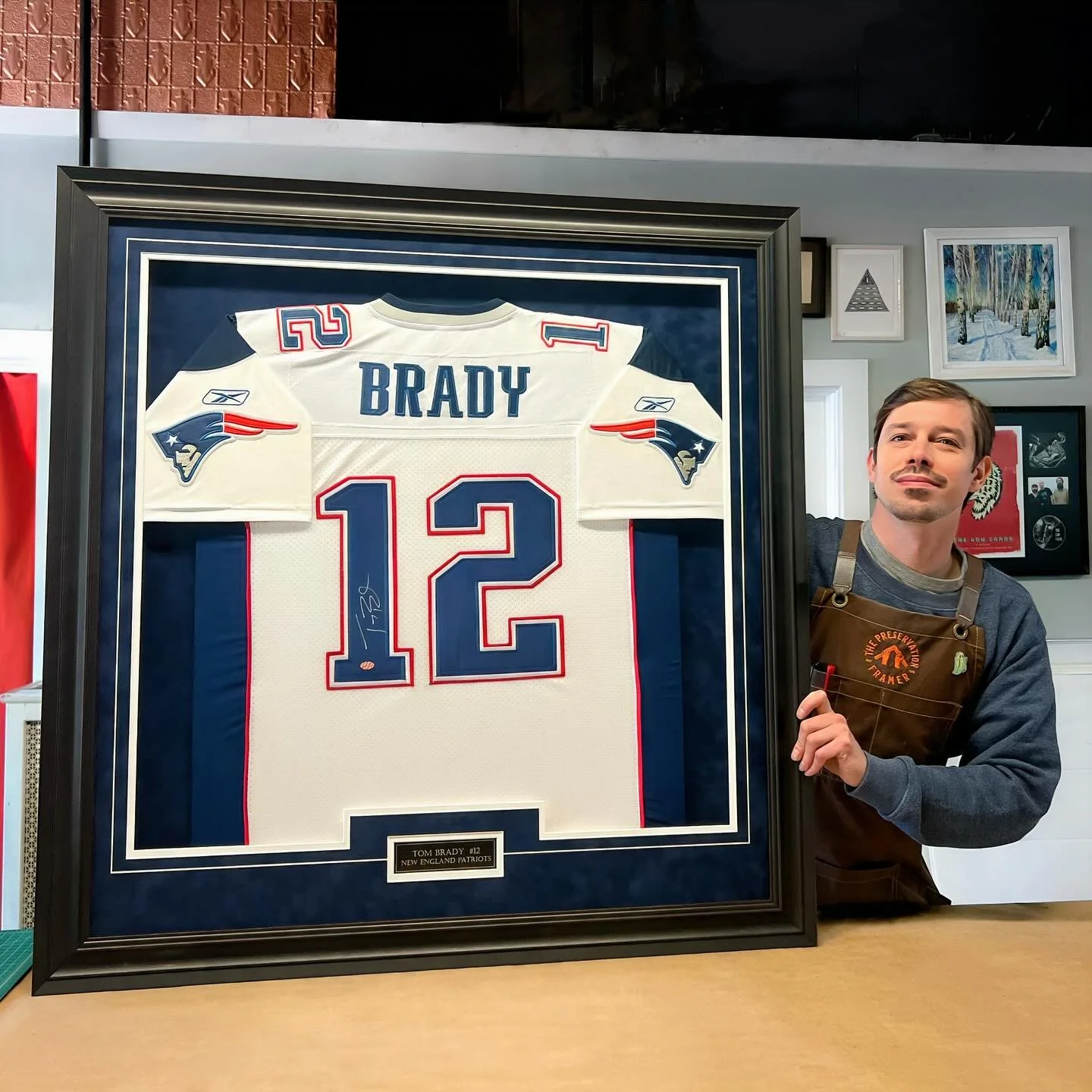 A redo for a customer, sorry no before pic, but trust us. The original was stapled to mat board and the frame had fallen apart. Here we shaped and sewed the jersey and made a build up for the top mat to sit keeping the glass off the jersey. A v-groov