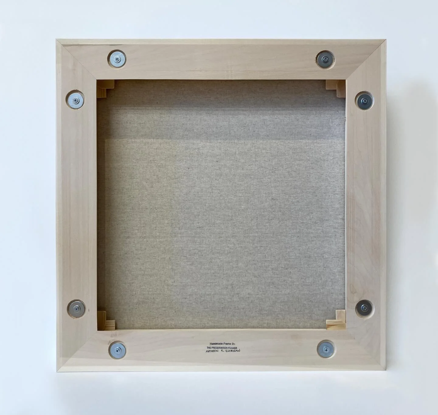 Back side photo first of a floater frame. This photo shows the assembly mechanisms for easy adjustment of the stretcher or spacing of the painting in the floater frame. By loosening the screws slightly you can readjust the canvas without having to dr