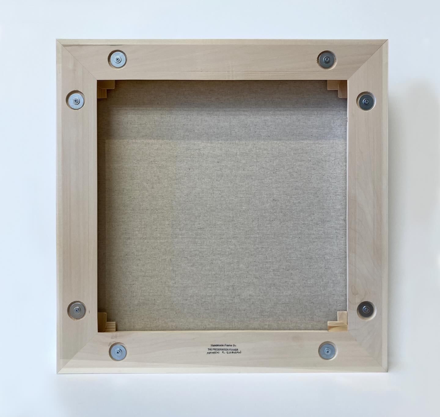 Back side photo first of a floater frame. This photo shows the assembly mechanisms for easy adjustment of the stretcher or spacing of the painting in the floater frame. By loosening the screws slightly you can readjust the canvas without having to dr