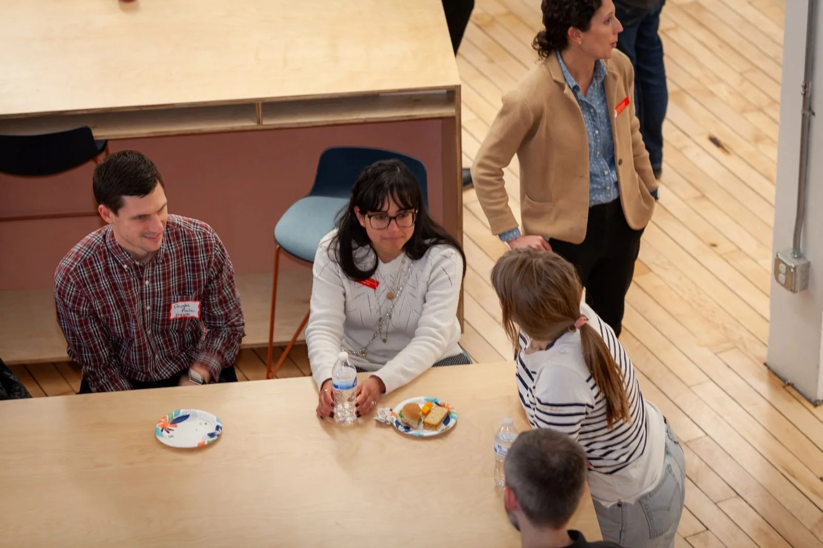 AIA Cincinnati members and friends connect after the program. Douglas Furia, Ximena Mellado Cuevas, Jamie Kruer, and John Edwards at table. Monica Lowry in background.