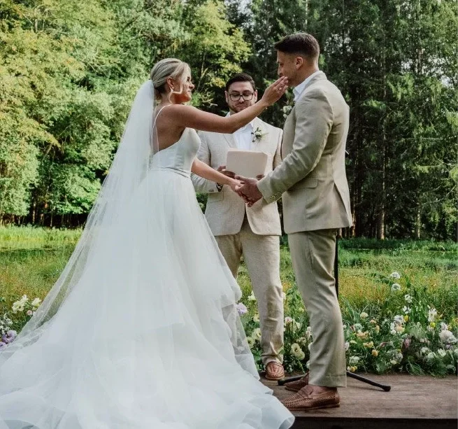 Couple exchanging vows during an outdoor wedding ceremony at Rest Co.'s scenic Catskills wedding venue.