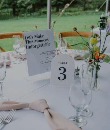 Elegant wedding and event table setup with floral arrangements and table numbers at a Catskills venue.