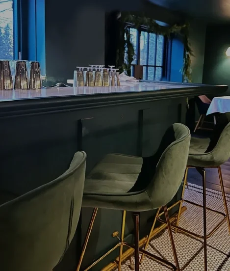 Upscale restaurant and bar interior with cozy seating and dark modern decor at a Catskills boutique hotel.