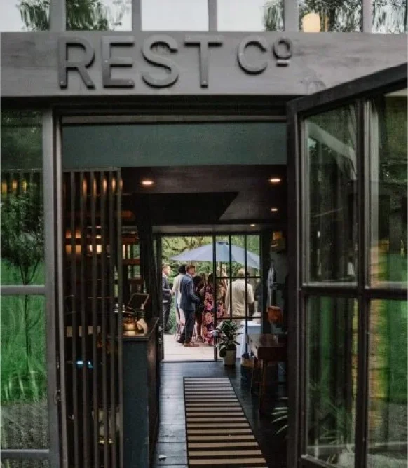 Entrance to Rest Co. boutique hotel and Catskills wedding venue leading to an intimate outdoor celebration.