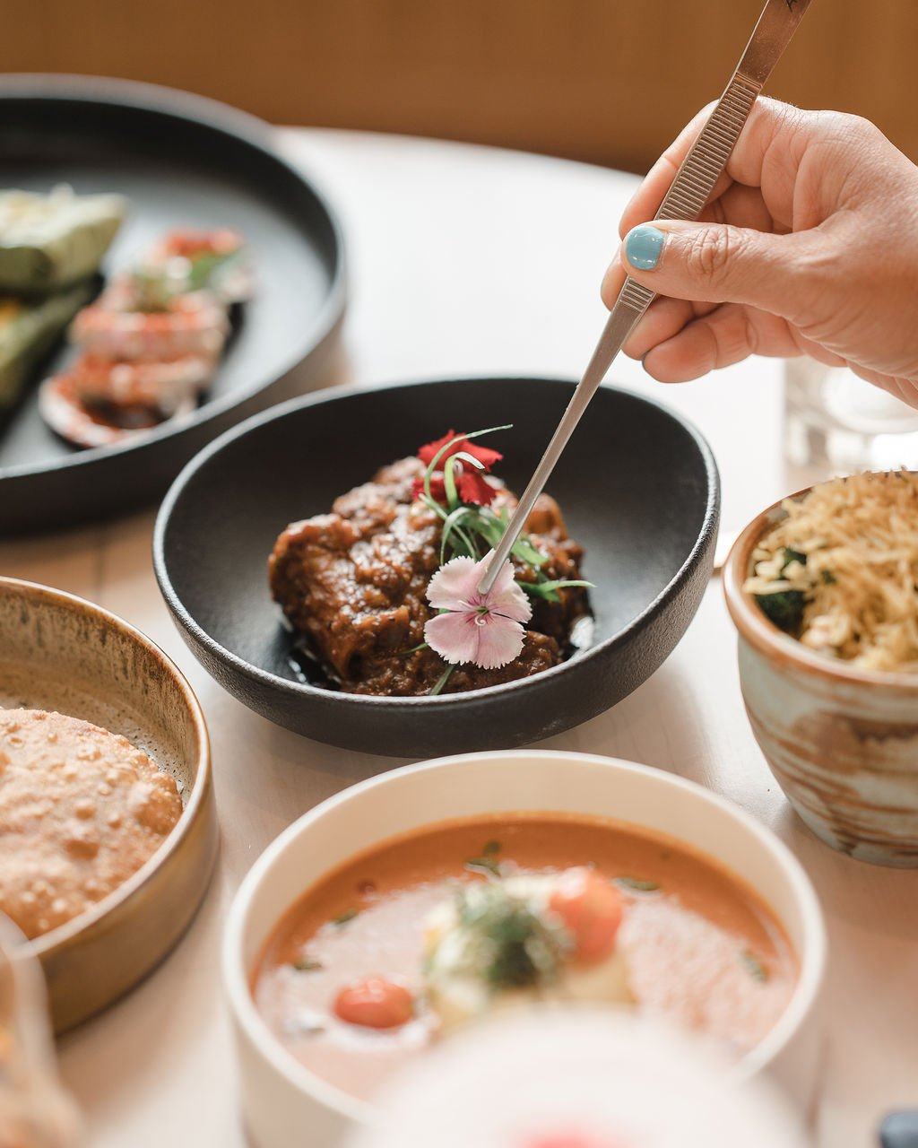 A spread of Elchi dishes being shared across the table