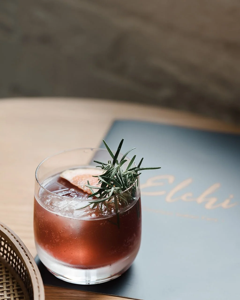 Elchi signature cocktail with a rosemary sprig