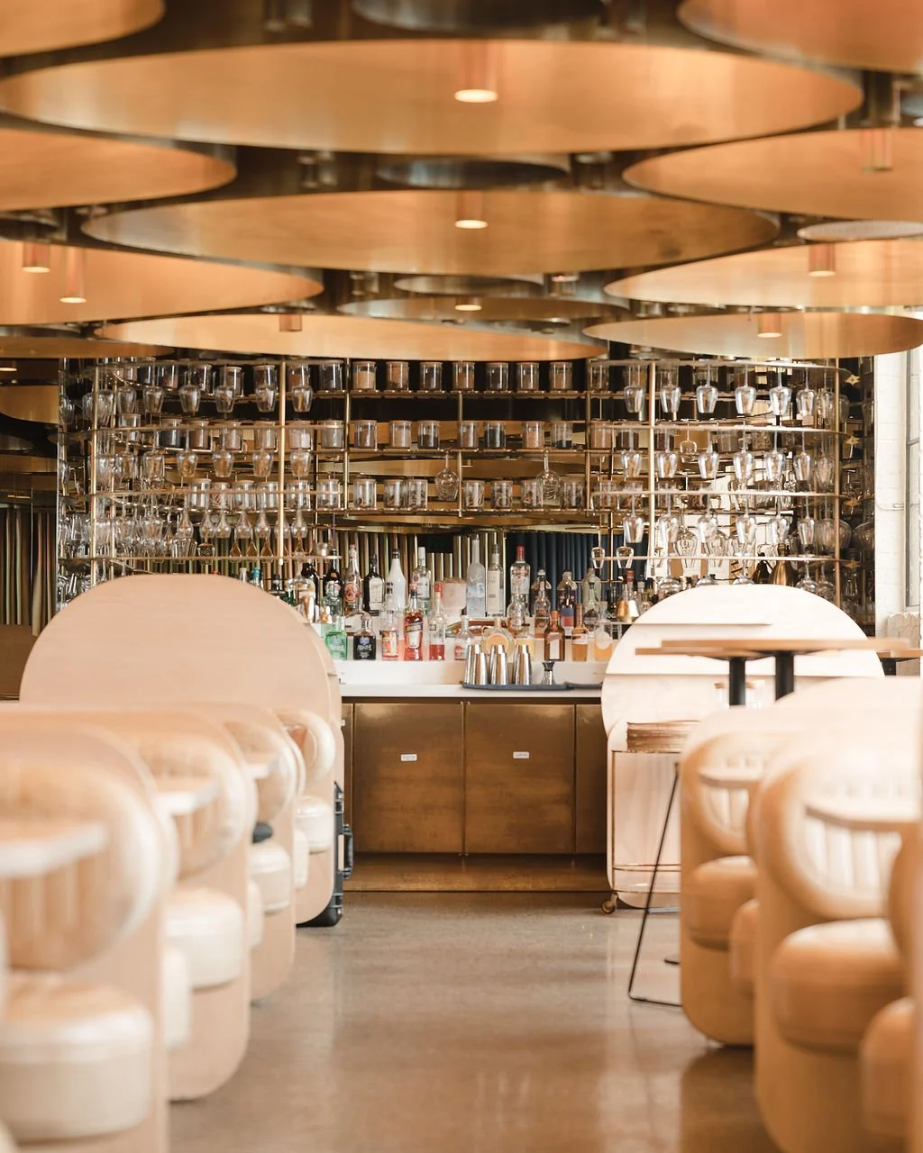 Cream booths leading to the bar in the Elchi dining room