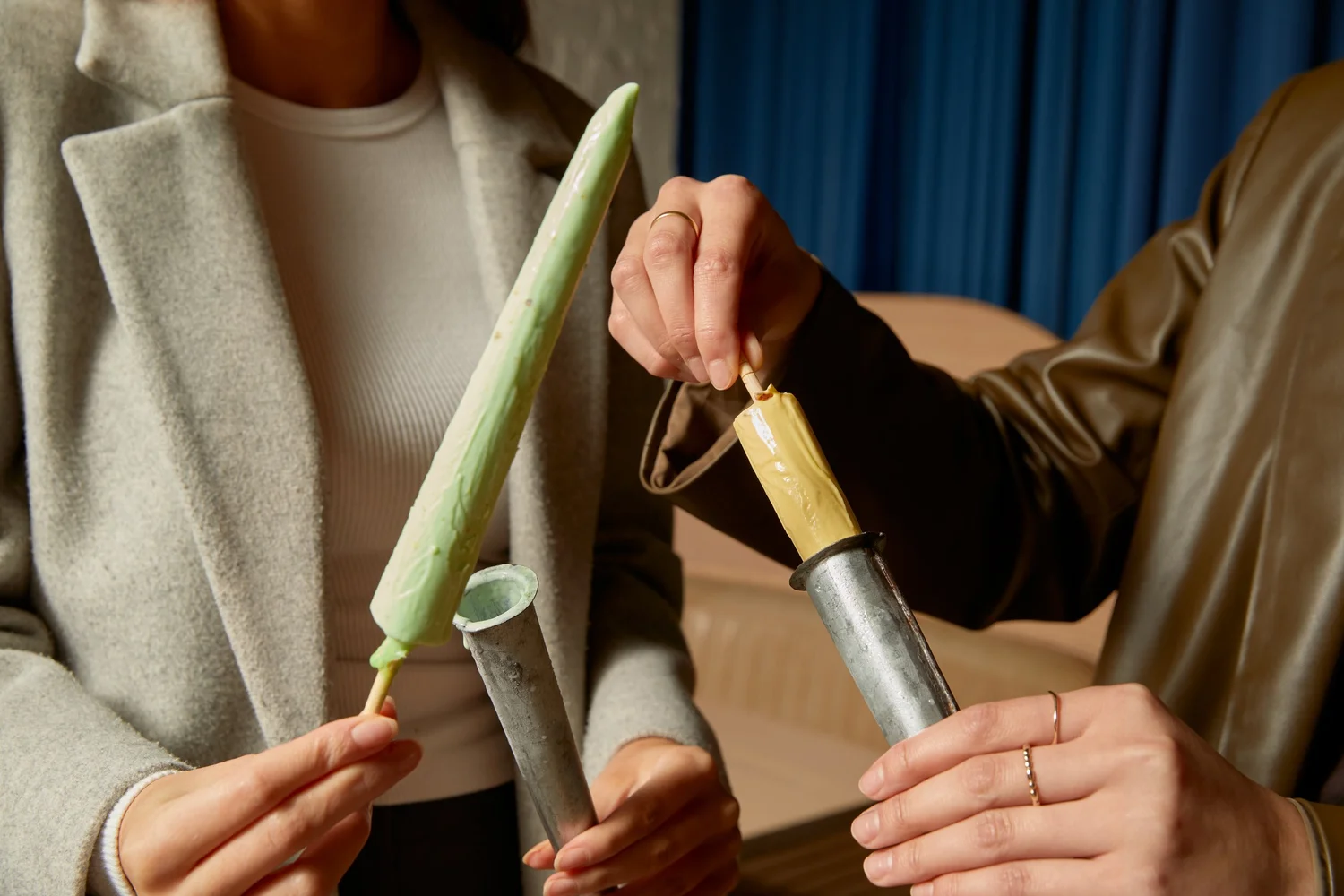 Kulfi being slid from traditional metal moulds