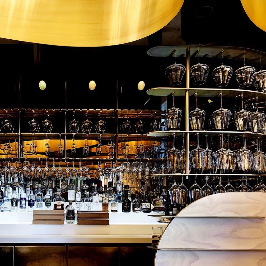 Elchi bar with illuminated bottle wall and gold ceiling