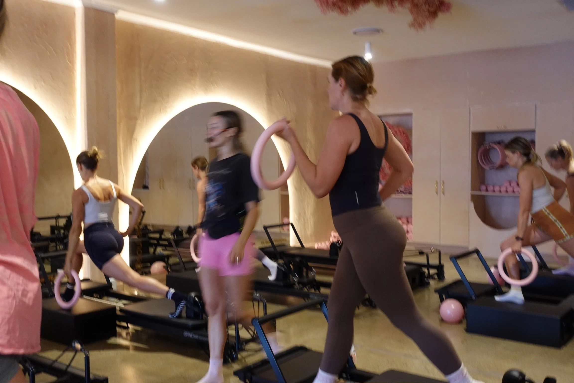 Members using Pilates rings in a reformer Pilates class at Soul Athletic Tugun