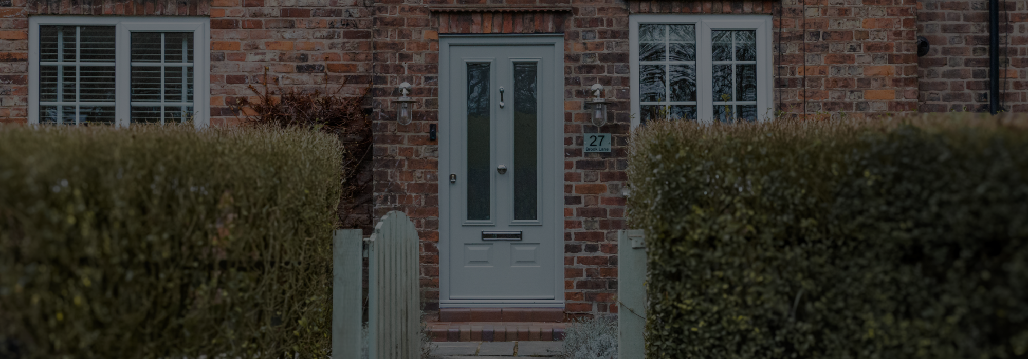 Front door with decorative glass panels in a hallway