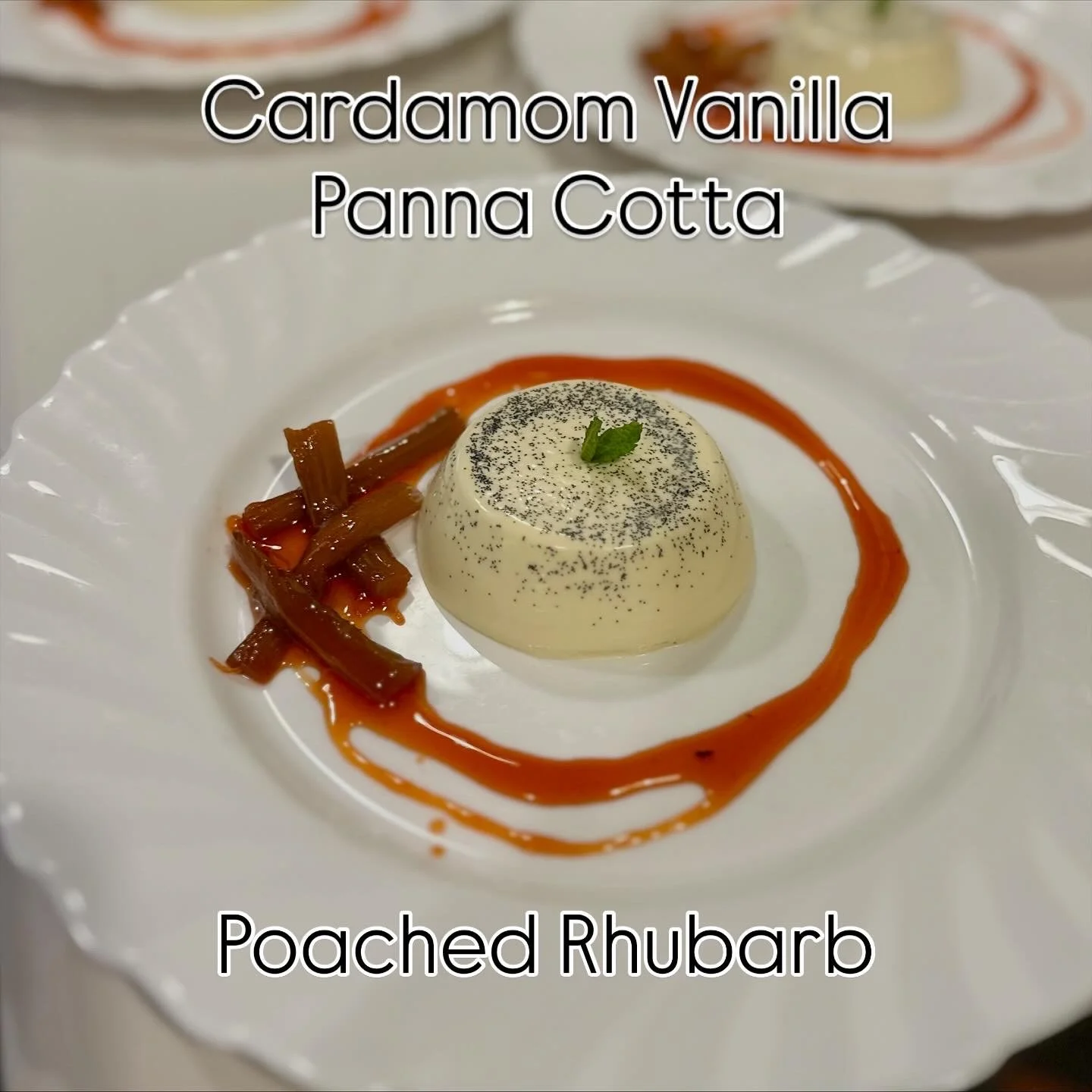 A dessert plate featuring a poached rhubarb with a vanilla cardamom panna cotta, garnished with a mint leaf and vanilla seeds, with a rhubarb sauce around the panna cotta.