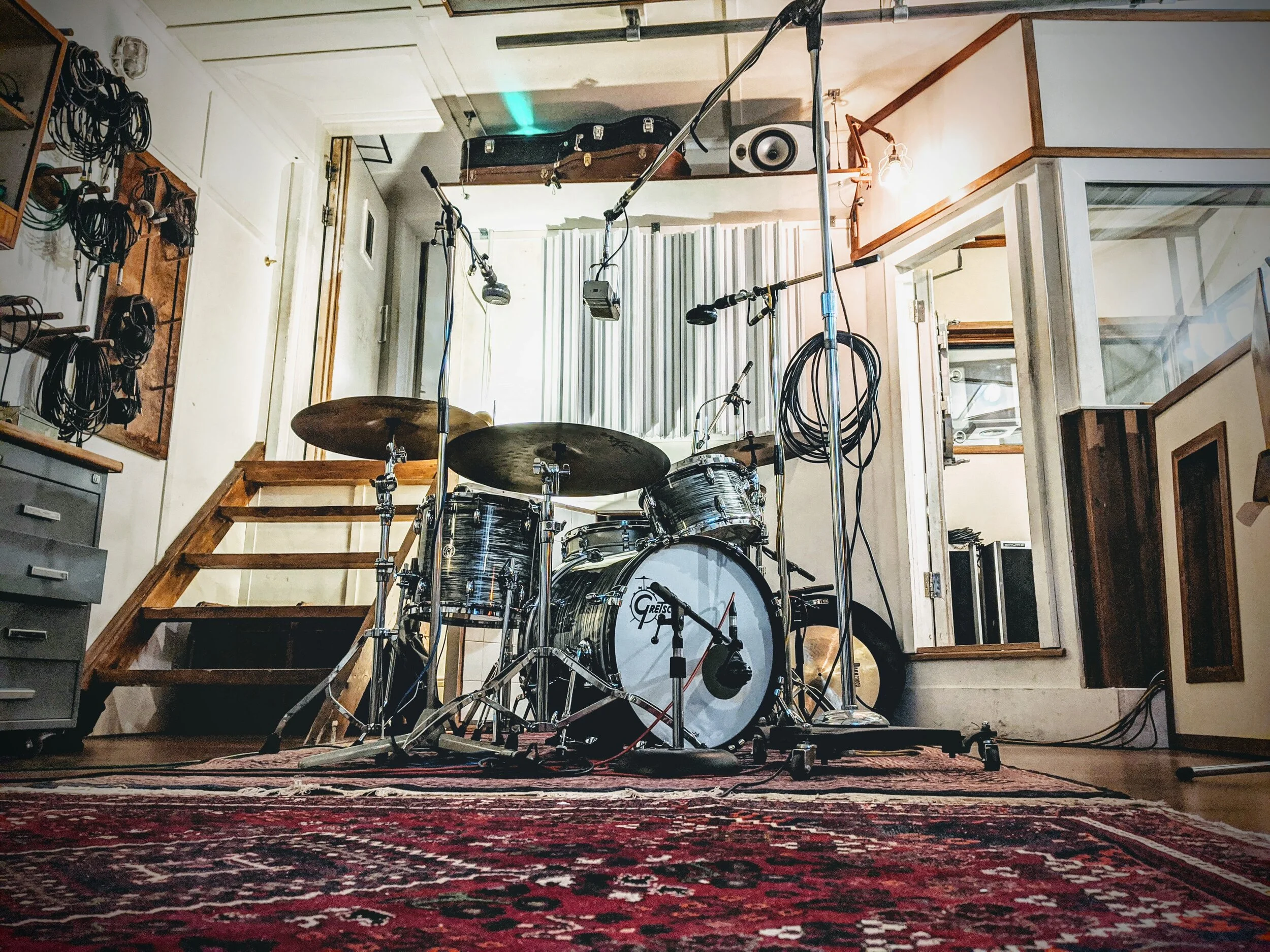 A drum kit is mic’d up in the studio