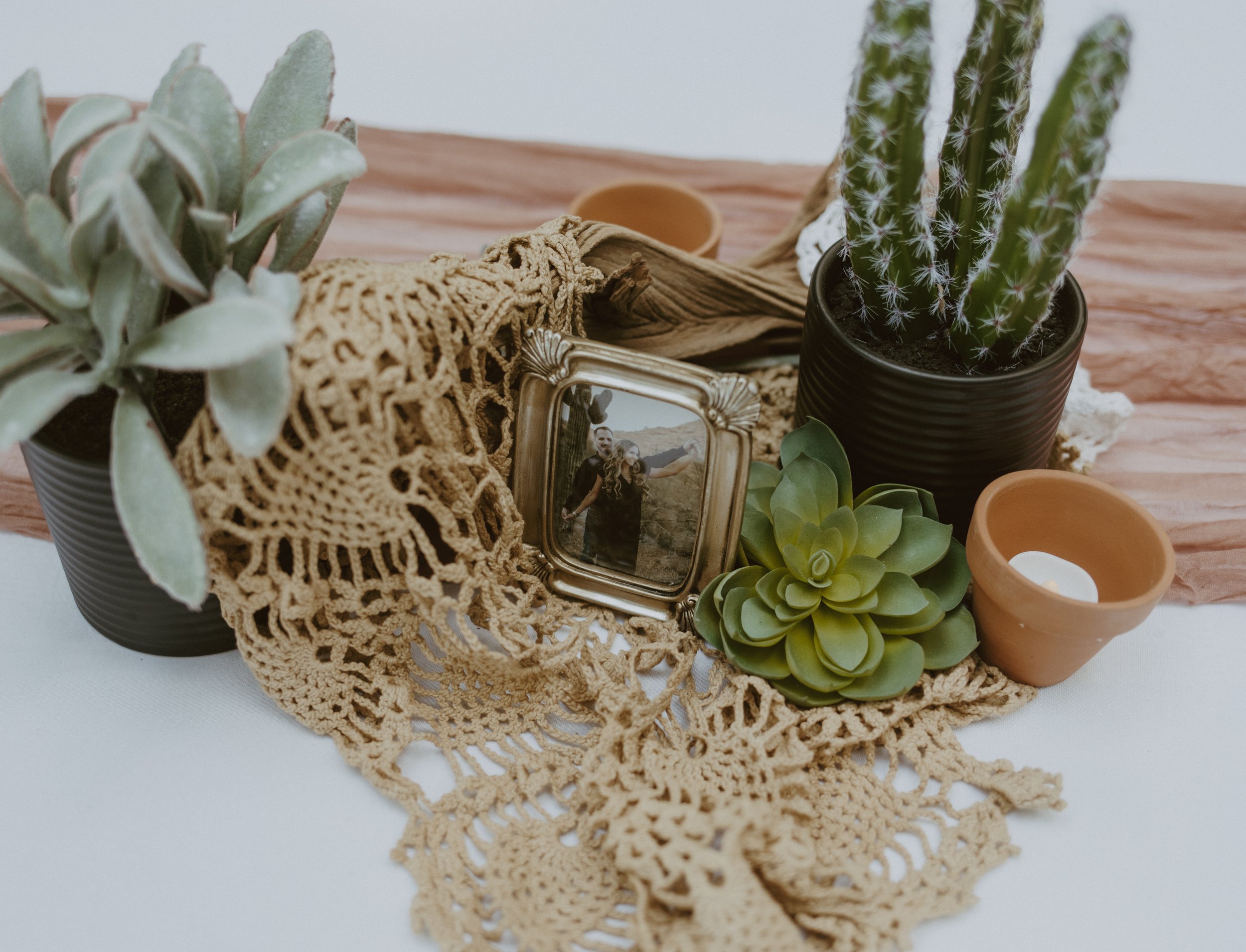 These guest table centerpieces were anything but boring! We layered so many details to create these one of a kind and beautiful tables. The bride loves vintage doilies, the grooms home is from the Arizona desert and she had a long lost pin with drif