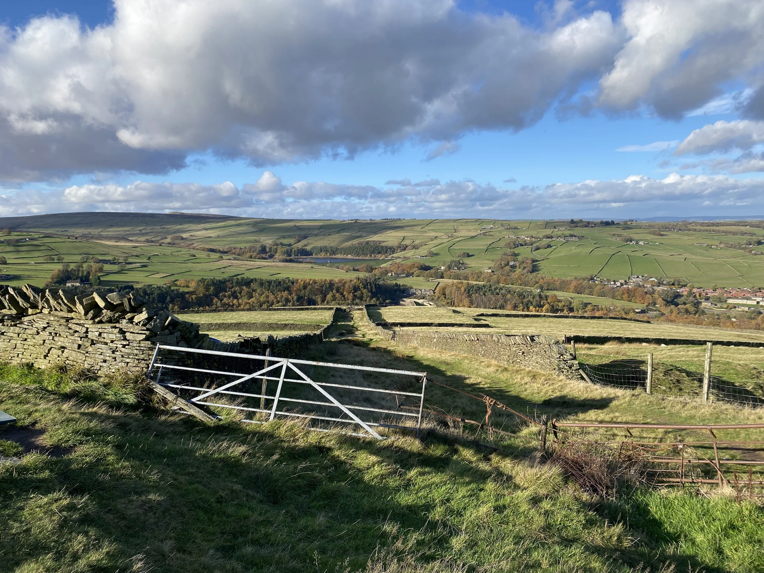 Moorland view from the hills above Holmfirth, with a gate in the foreground and far reaching views