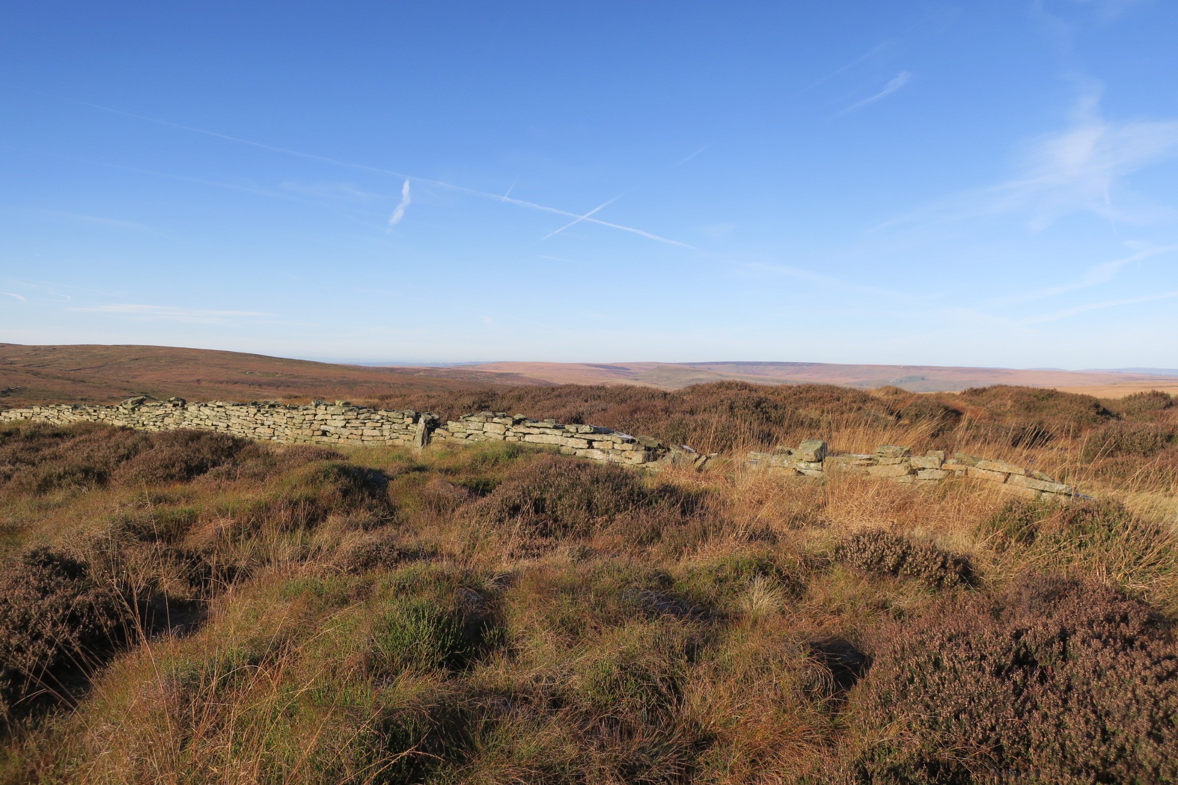 Moorland view, with dry stone wall and blue sky taken on Black Hill, Peak District