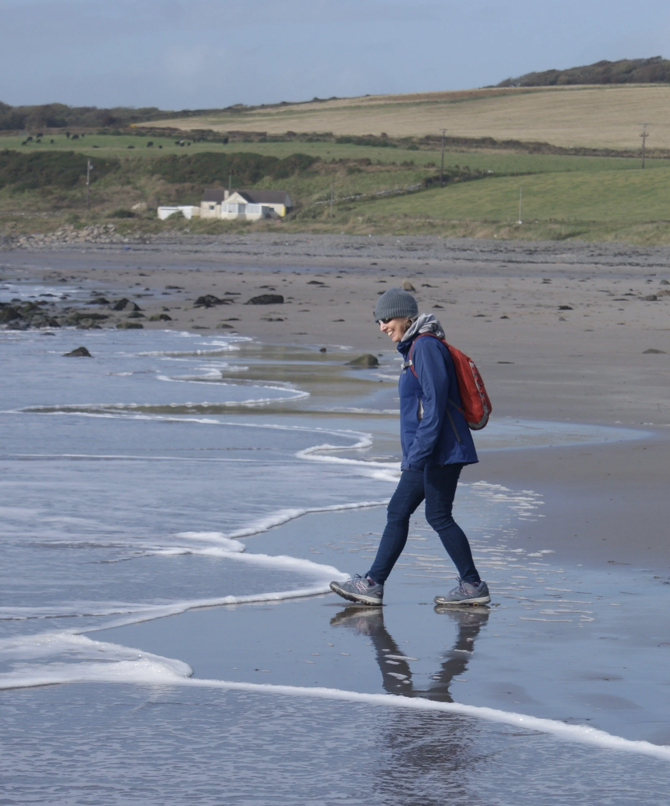 Jacquie Budd on the beach shoreline at Port Logan, Scotland