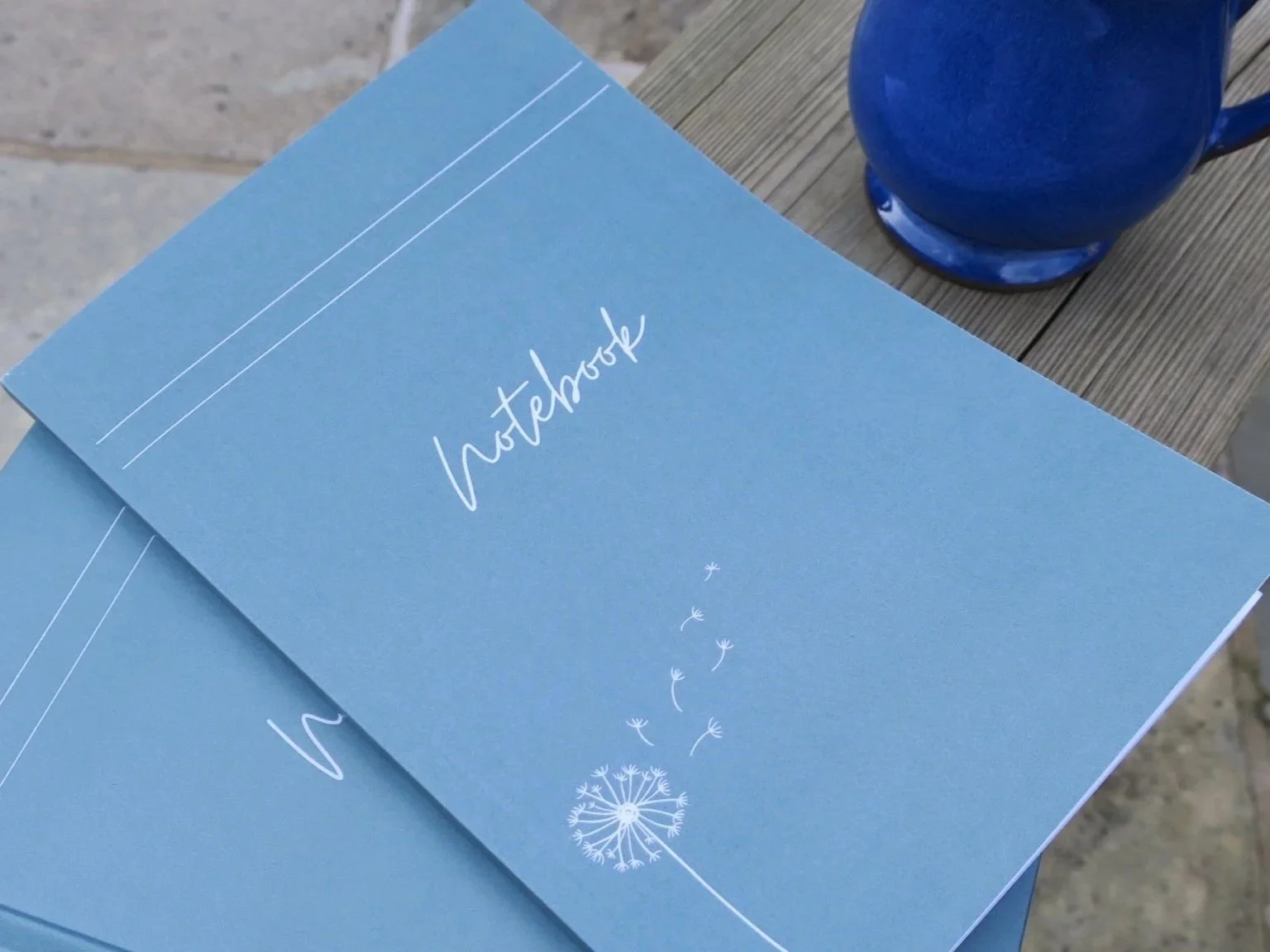 Inspiration for writing with notebooks and blue cup