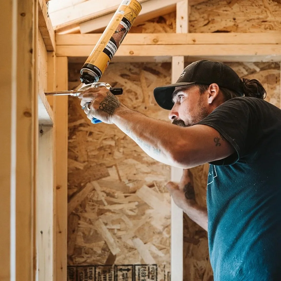 Man working on the framing of a farmhouse addition.