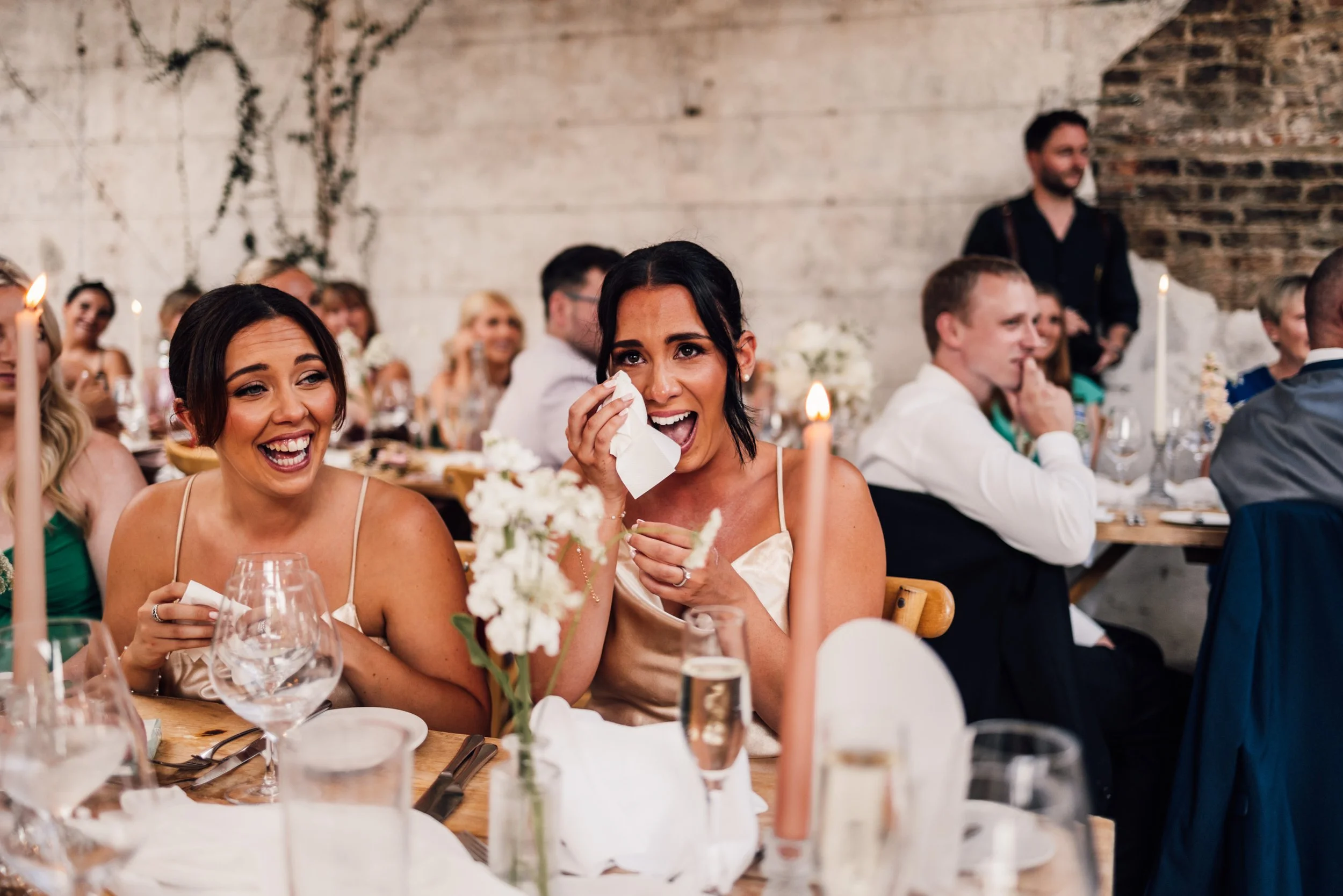 candid moment of emotional bridesmaids during the speeches at Middleton lodge wedding