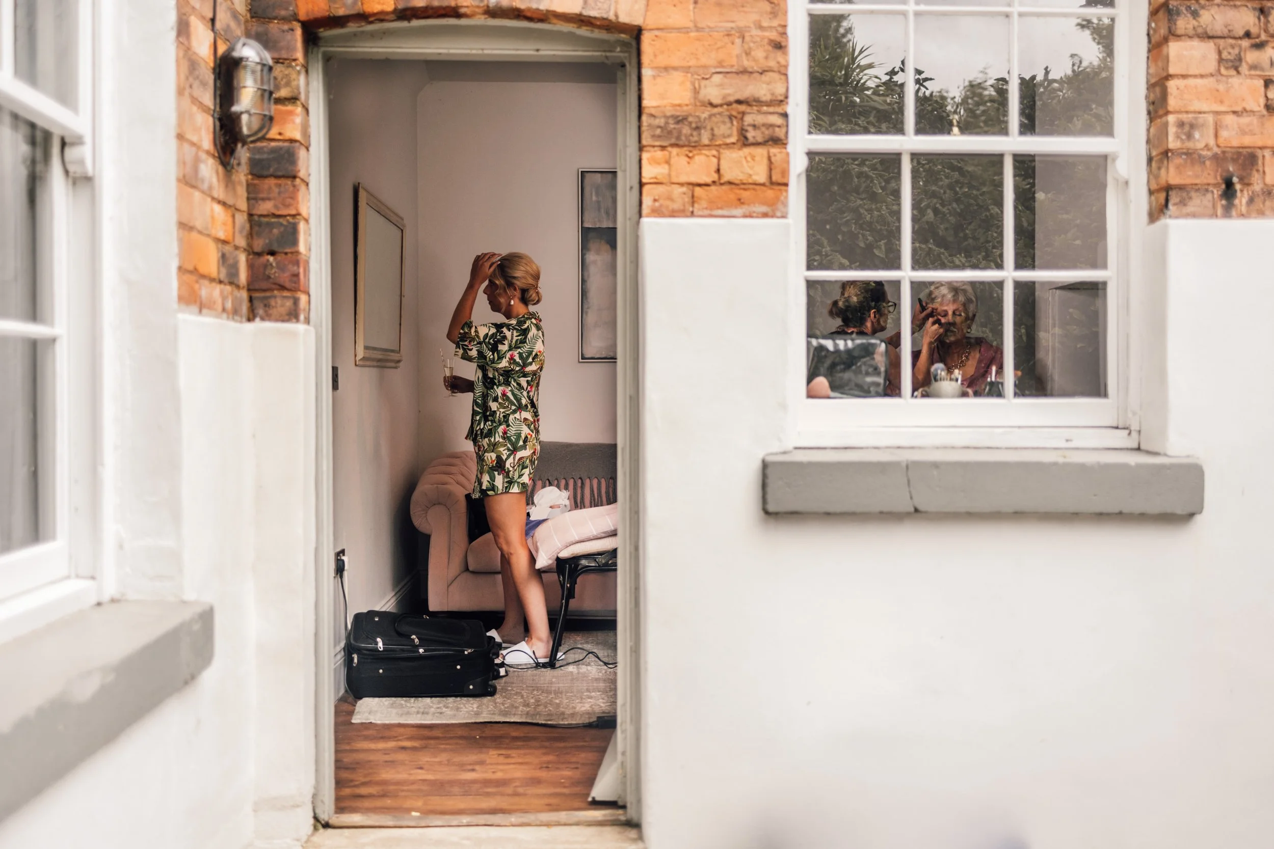 Natural, unposed photo of bride getting ready with bridesmaids