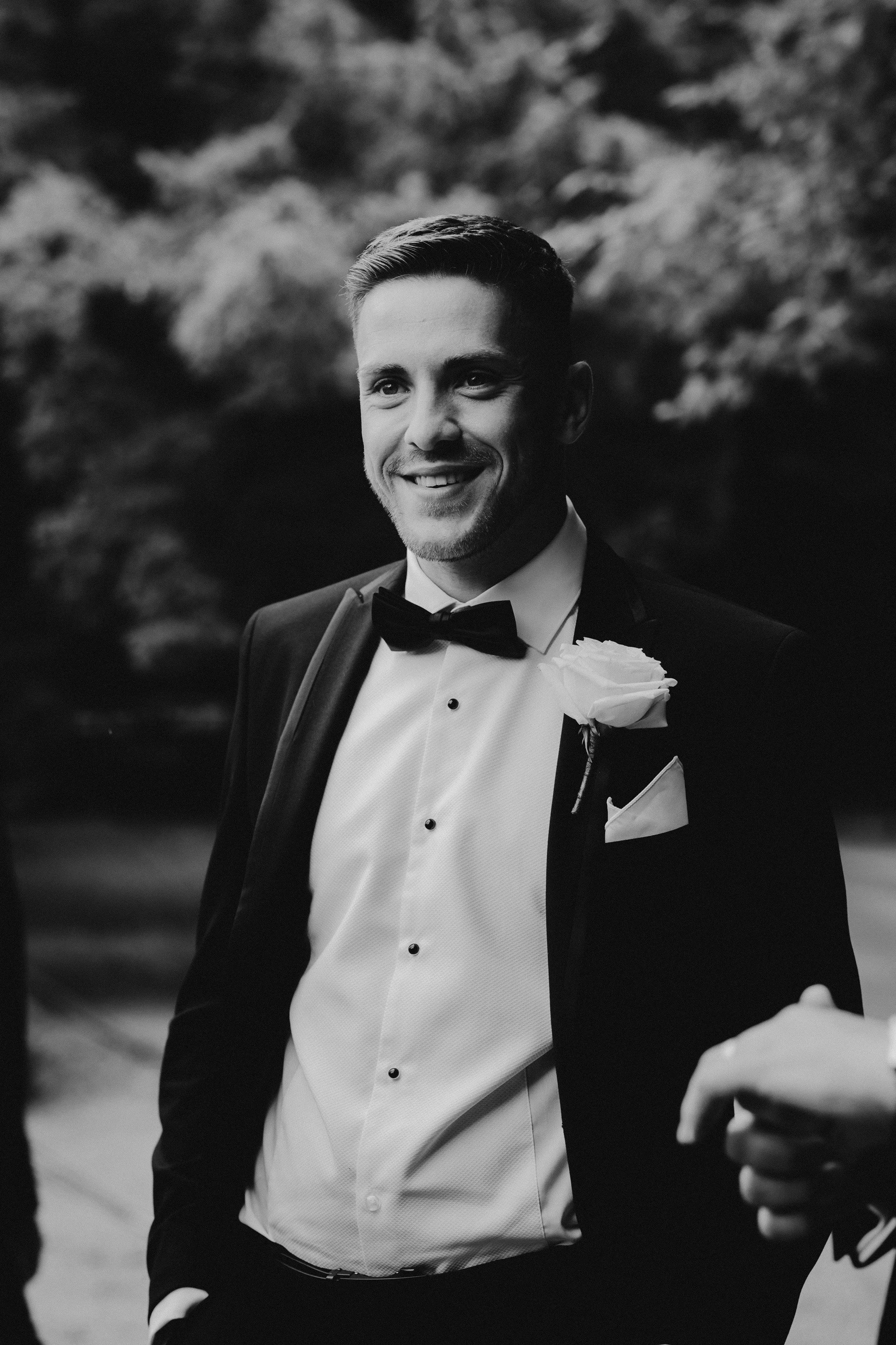 Black and white photo of a groom wearing a tuxedo before his Middleton Lodge wedding