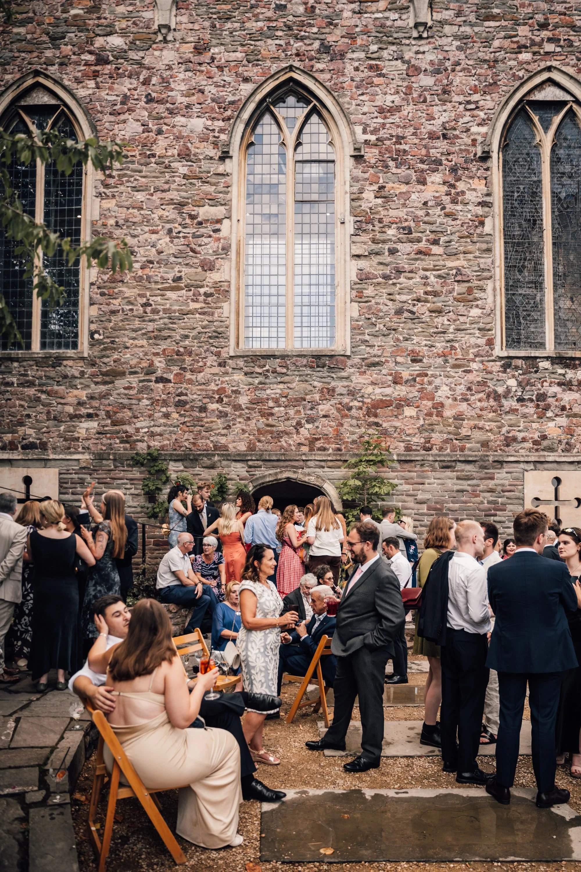 Guests laughing during relaxed documentary wedding reception in Bristol