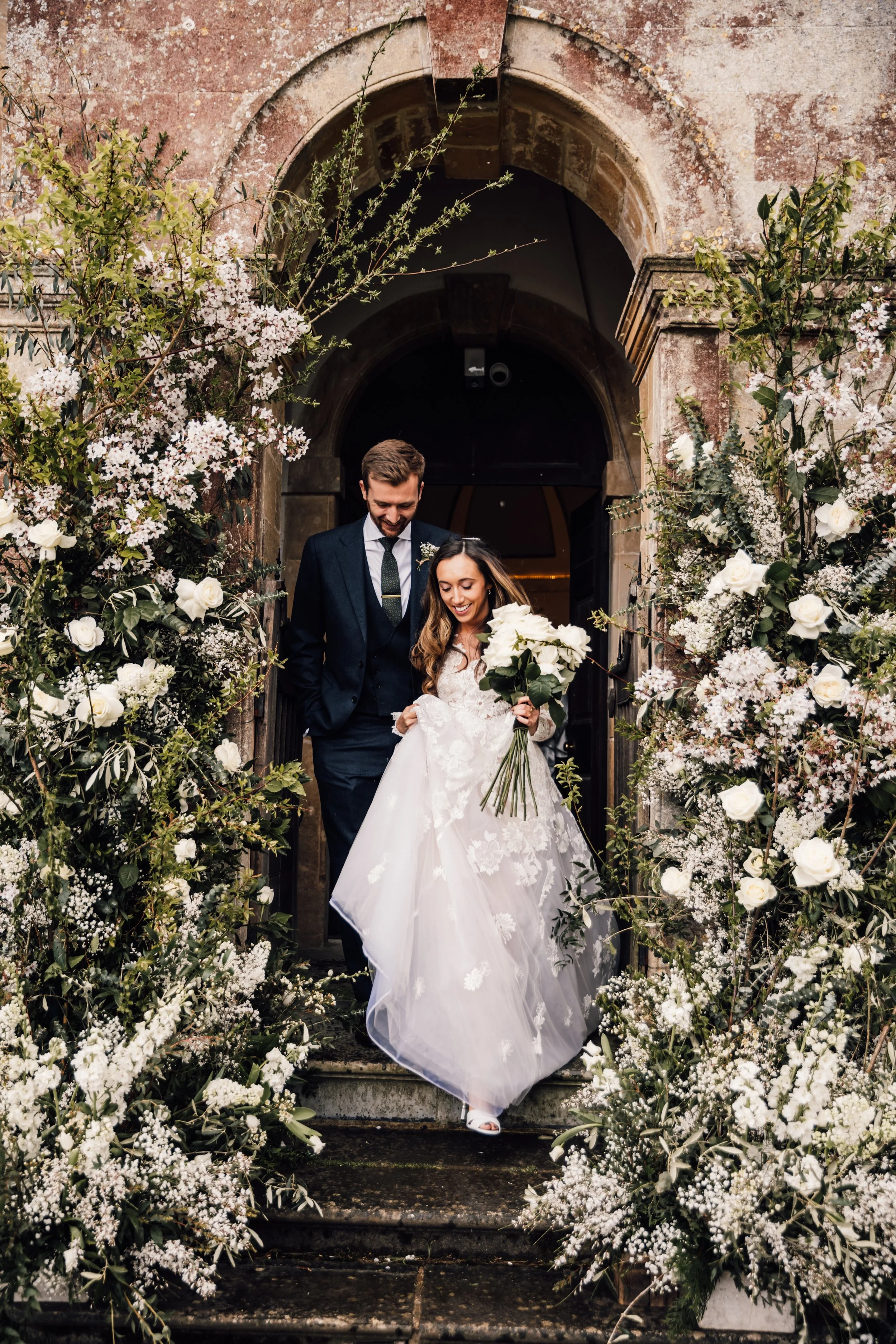 Bride and groom exit Chapel at Babington House, Frome