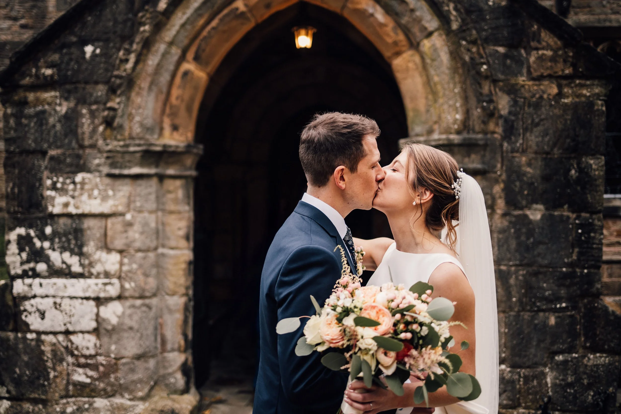 Candid wedding photo of bride and groom after church wedding in derbyshire