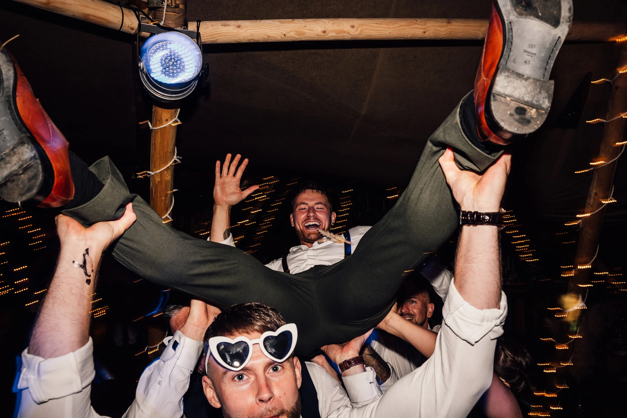 Dancefloor photo of derbyshire wedding with groom being lifted in the air