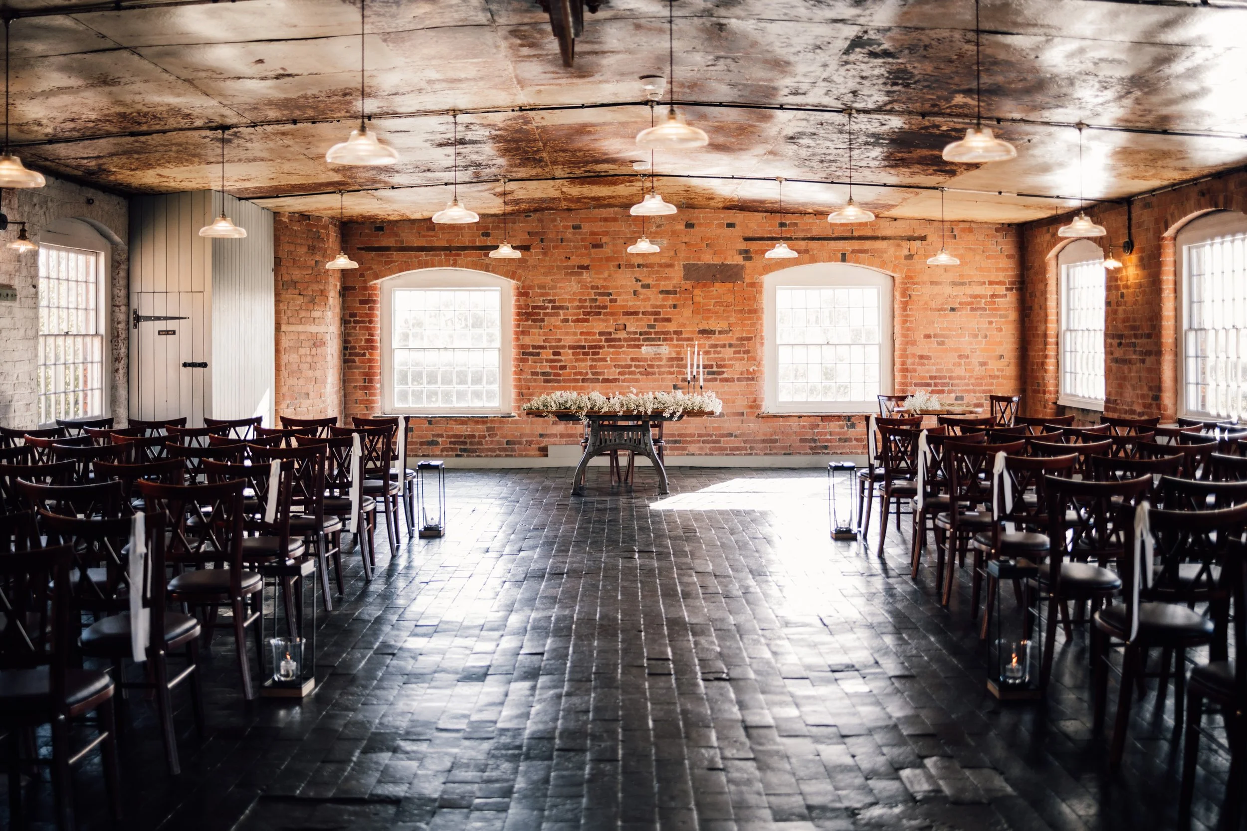 Minimalist wedding ceremony with white florals and documentary-style photos