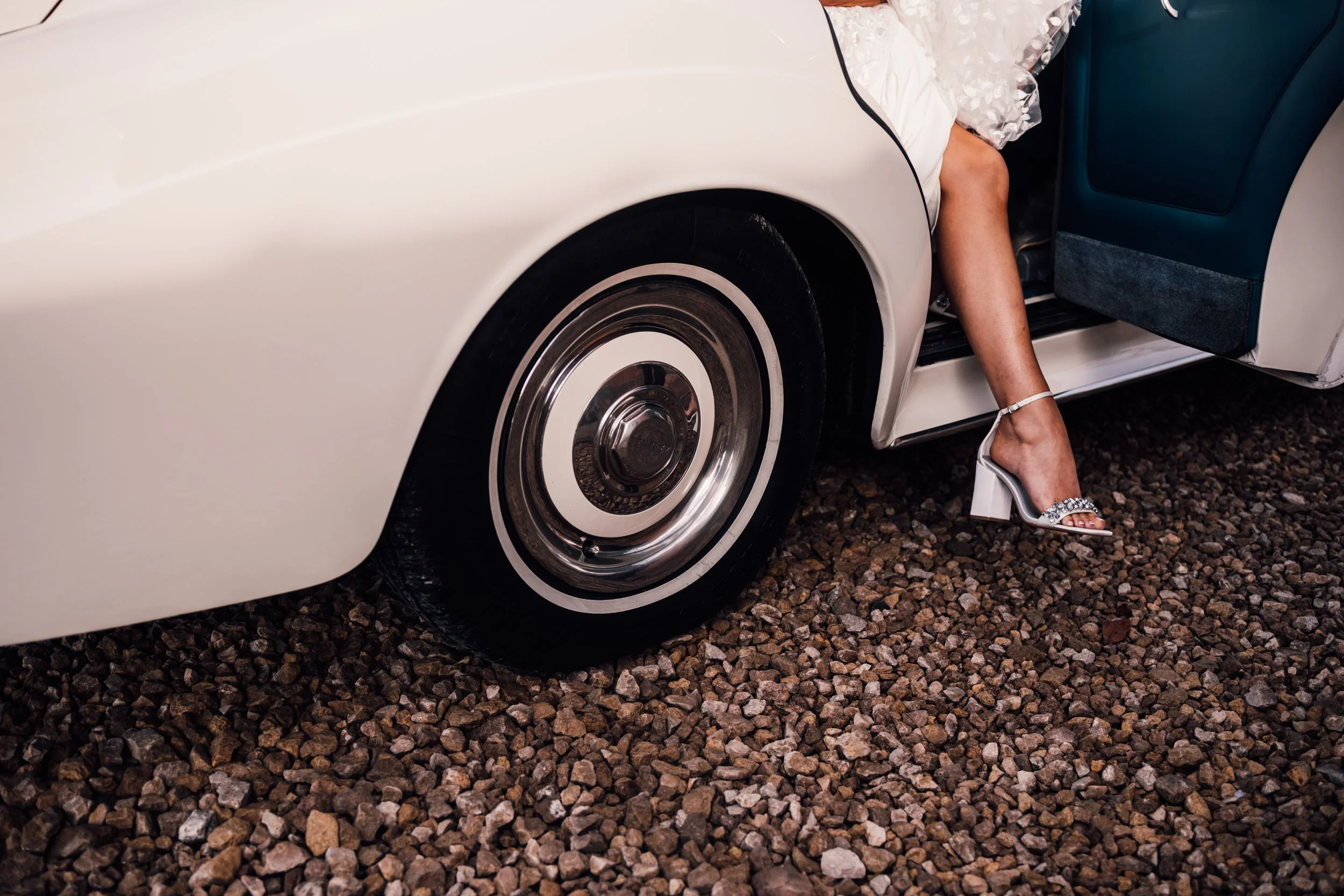 Bride exiting the wedding car at Grangefields wedding