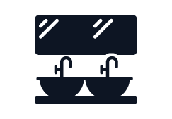 Silueta de un lavabo con espejos arriba y dos grifos.