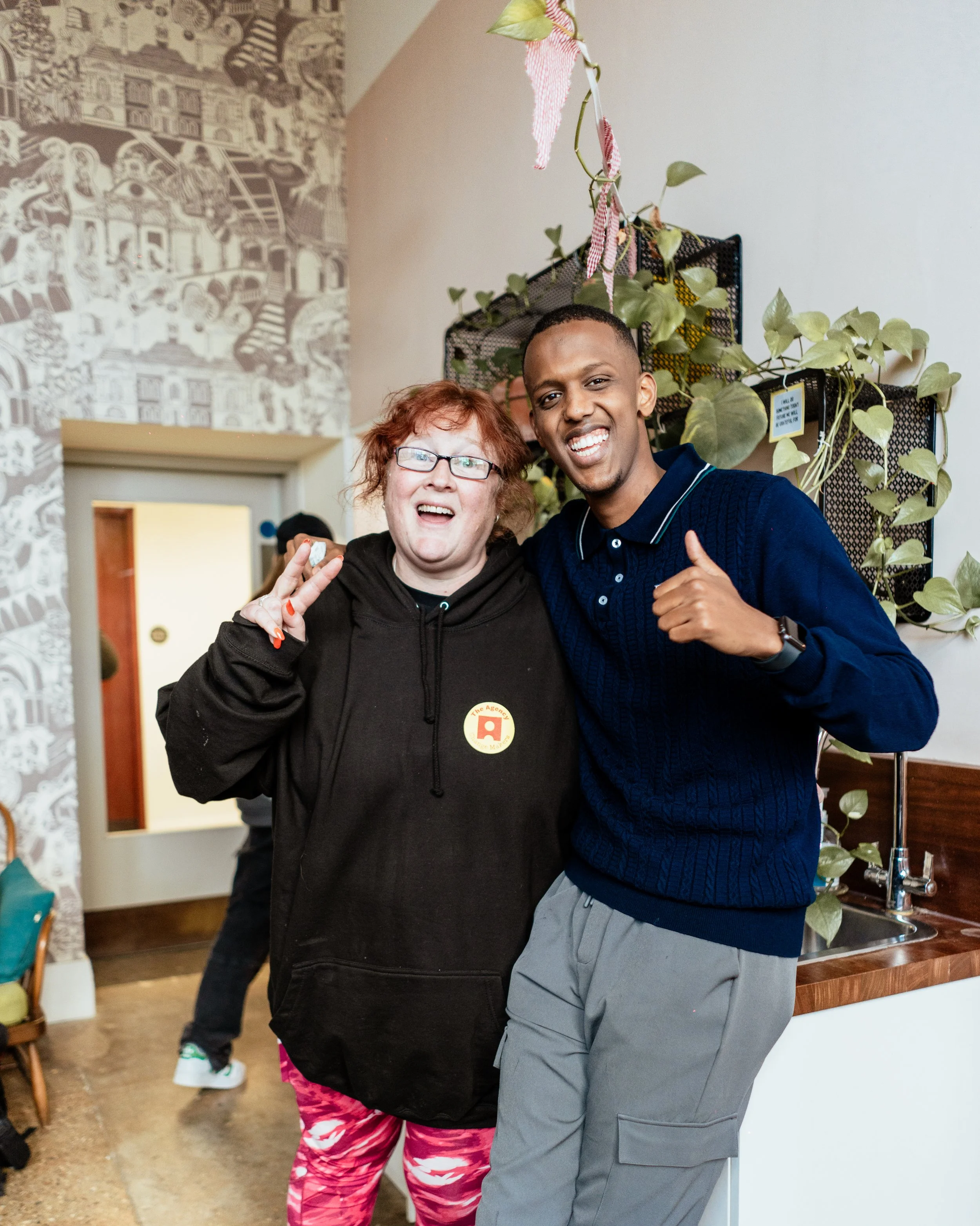 A group image of a woman and a young man with cheerful smiles.