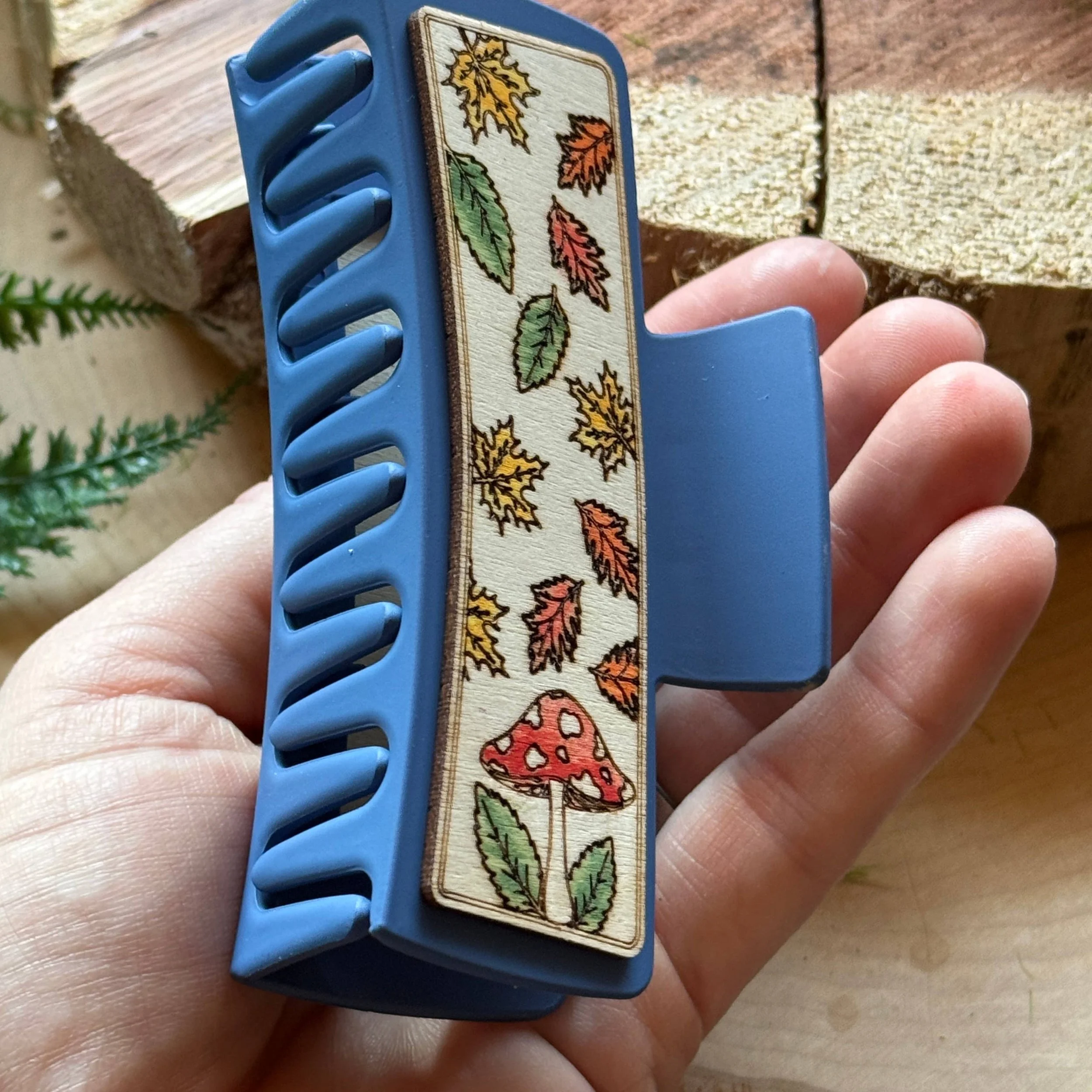 4" insh mushroom hair clip in the palm of a womens hand