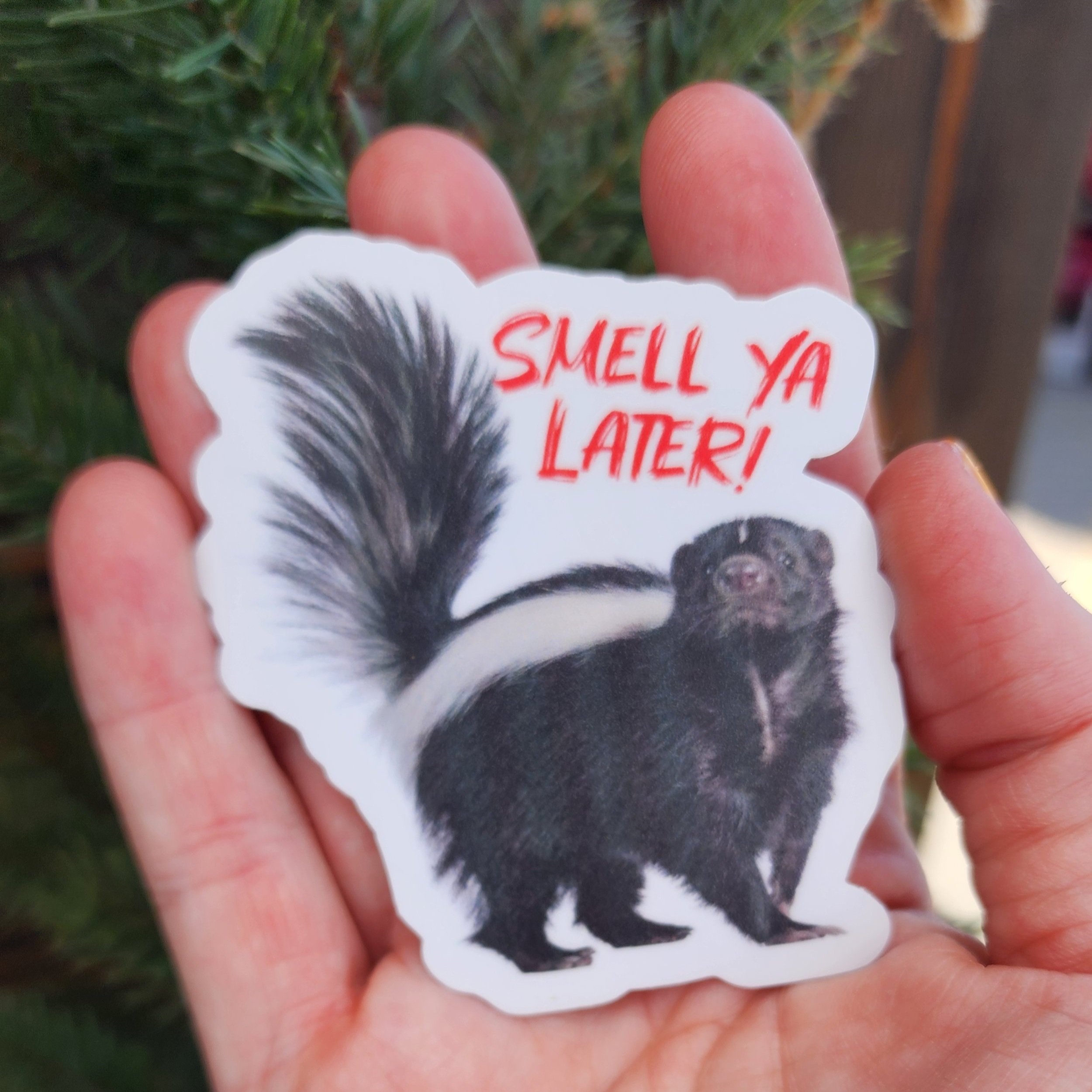 Smell Ya Later Skunk 3" sticker shown in palm of a hand