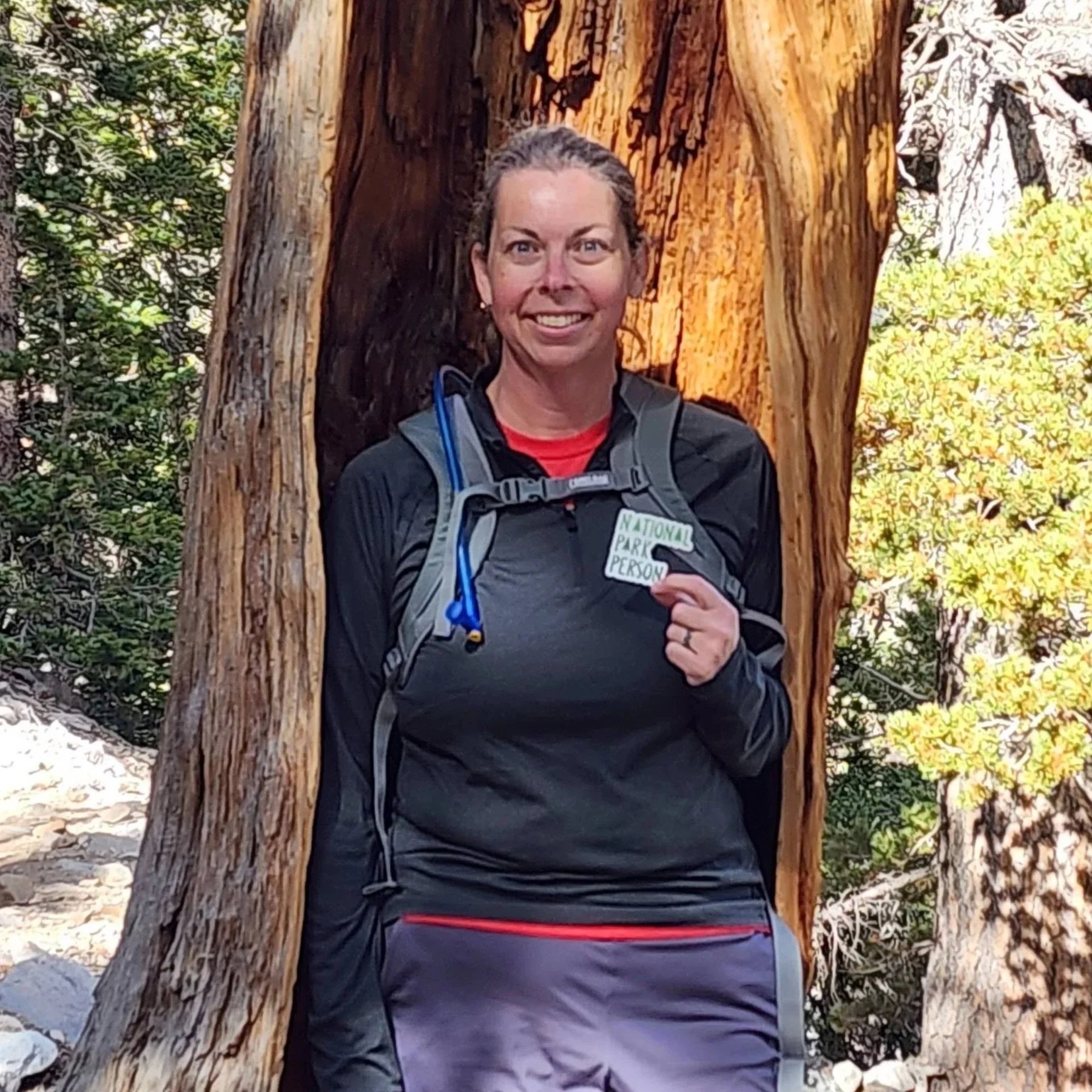 Laura, National Parks and Beyond's Owner in Great Basin National Park holding the National Parks Person Sticker