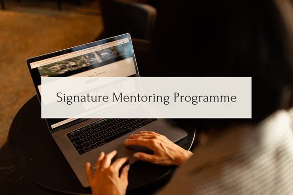 Person working at laptop with banner covering picture which reads signature mentoring programmer