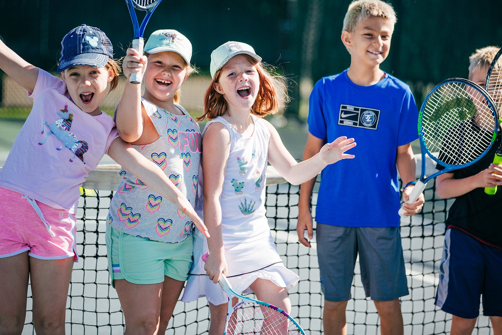 Young players learning tennis fundamentals in a fun group setting in Huntwick, Houston.