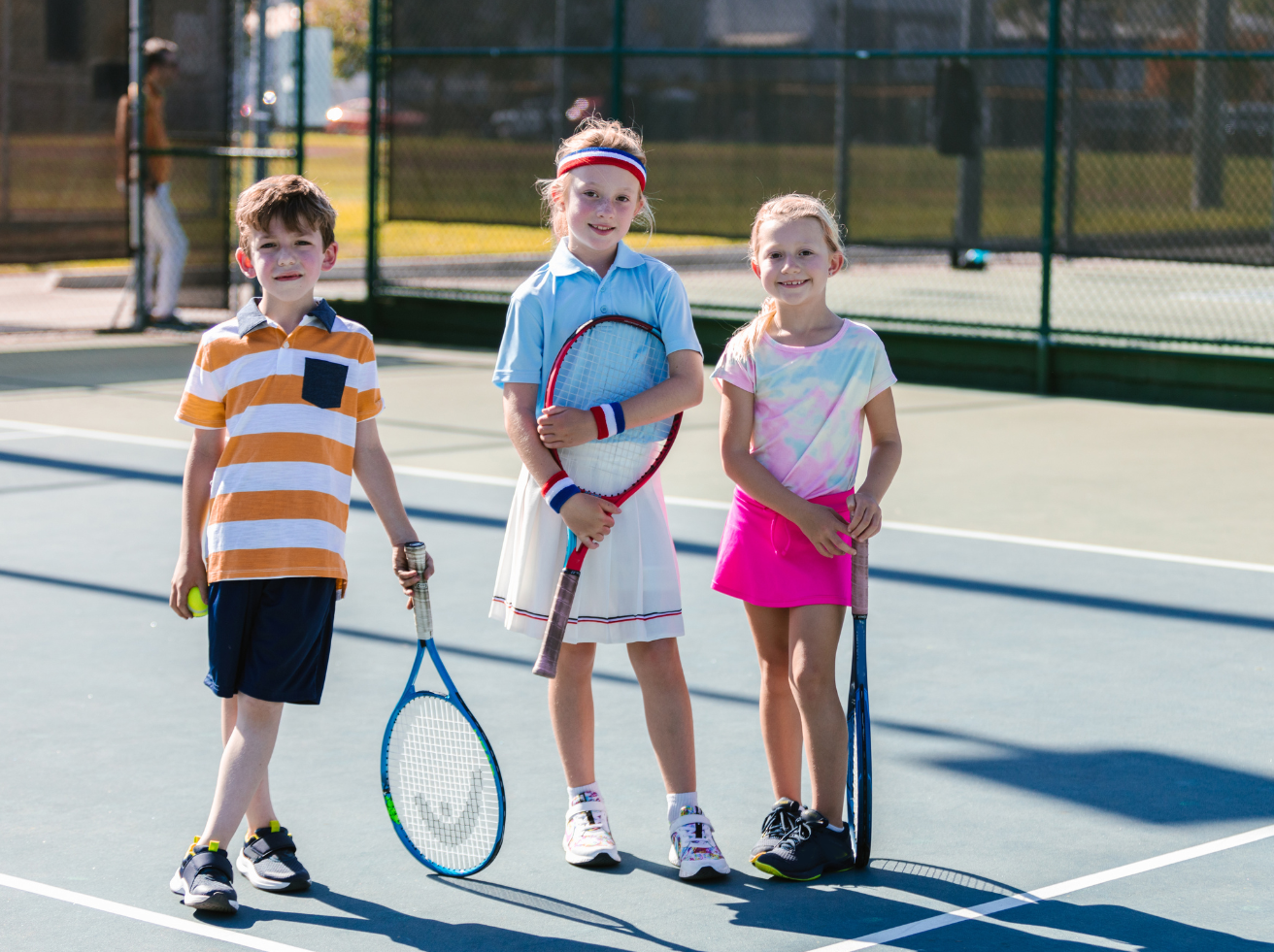 Kids tennis group lessons held on outdoor courts with age-appropriate drills and games.