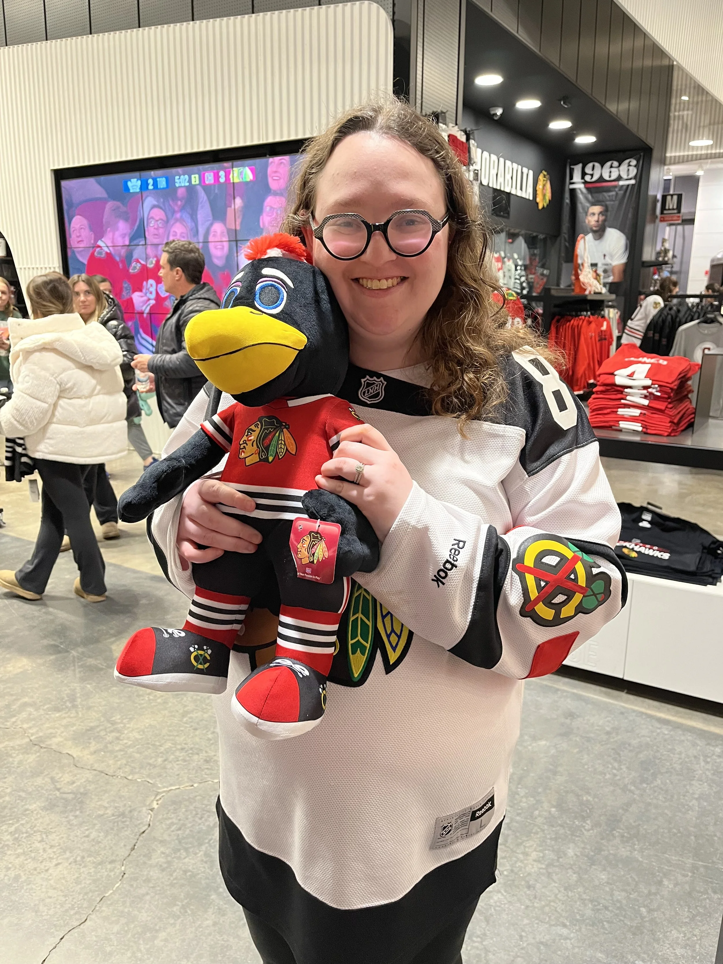 Allison with Stuffed Tommy Hawk at the Backhawks Game.jpg