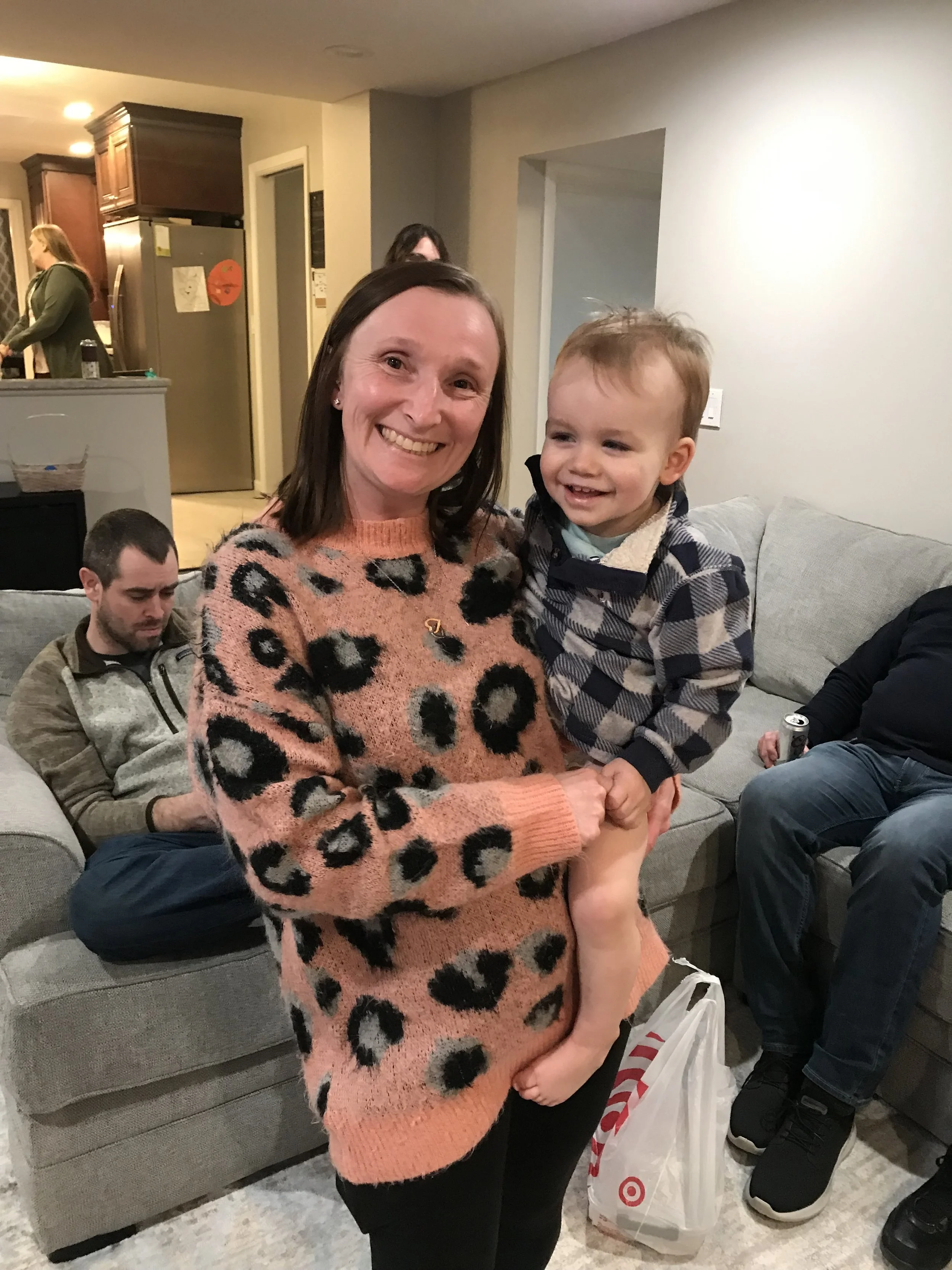 Megan holding wyatt at a family party.jpg