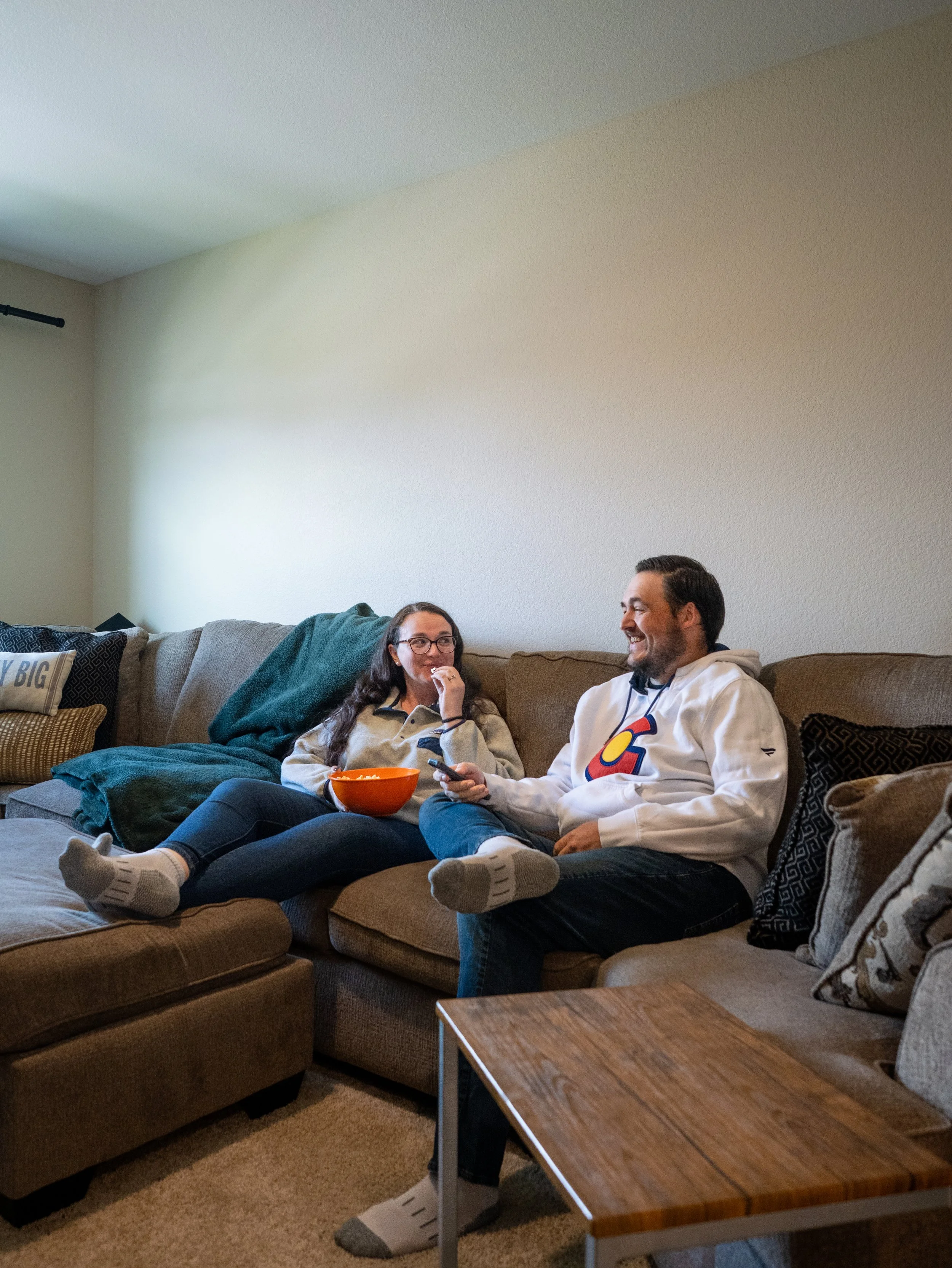 Angie and Russ enjoying a movie in their family room.jpeg