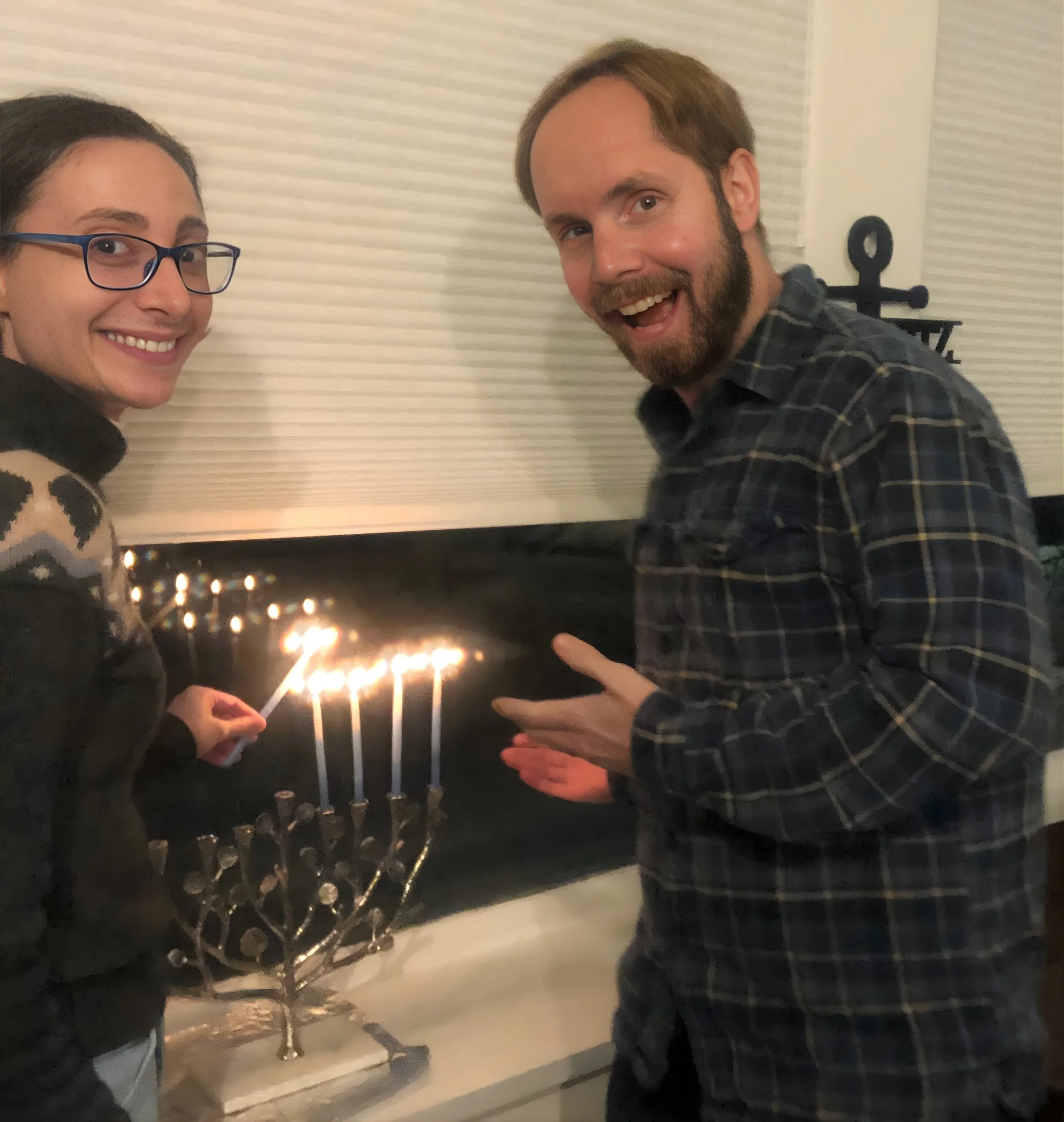We light candles, eat jelly donuts, and spin driedles during Hannukah.jpg