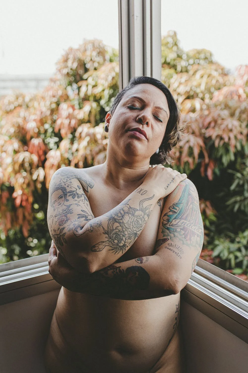 medium or large sized body with tattoos holding itself symbolizing the inclusivity of bodies of all shapes and sizes. body positivity. health at every size.