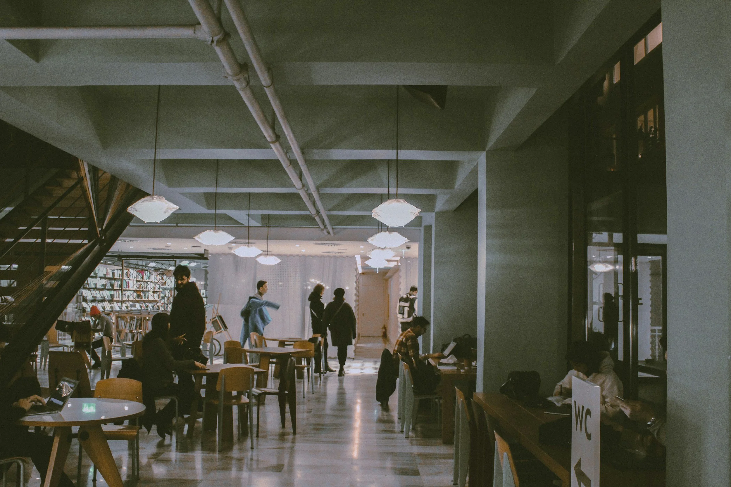 a busy public library as an example of a challenging public space for neurodivergent folks