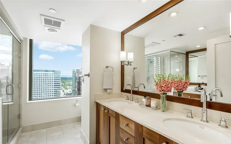 Spa-style bathroom with double vanity and city views at One Lincoln Tower