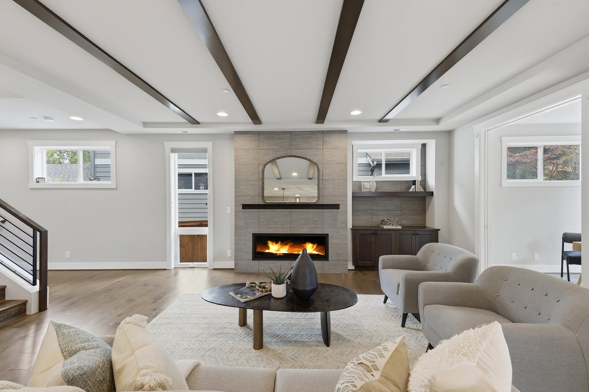Family room with stone fireplace and built-in shelving, English Hill luxury home Redmond