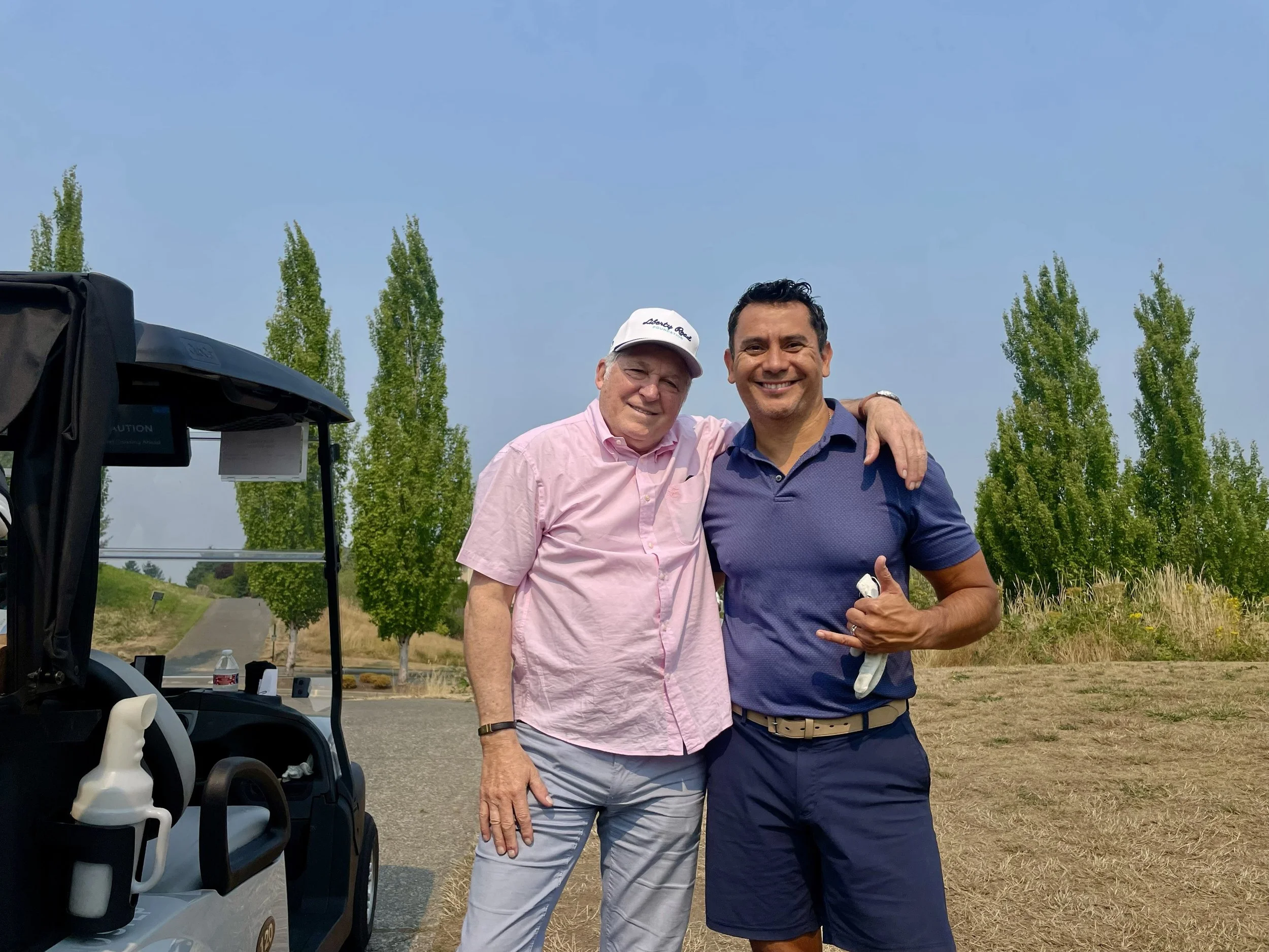 Freddy Delgadillo with fellow golfer at Liberty Road Foundation tournament, Newcastle Golf and Country Club