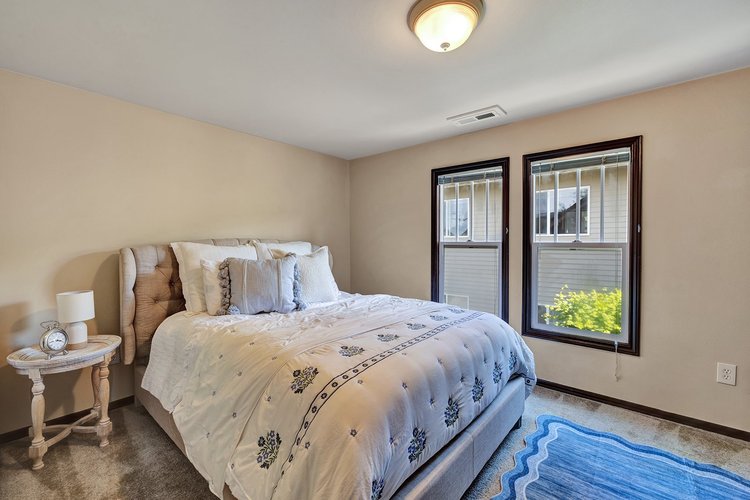 Spacious primary bedroom with walk-in closet, double windows, and neutral finishes in historic Downtown Issaquah home